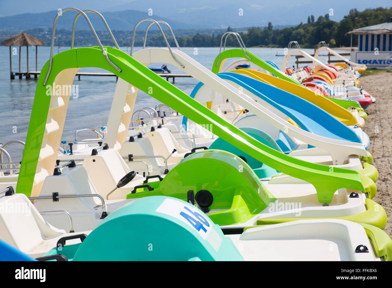 Colorful pedal boats aligned on a beach Stock Photo Alamy