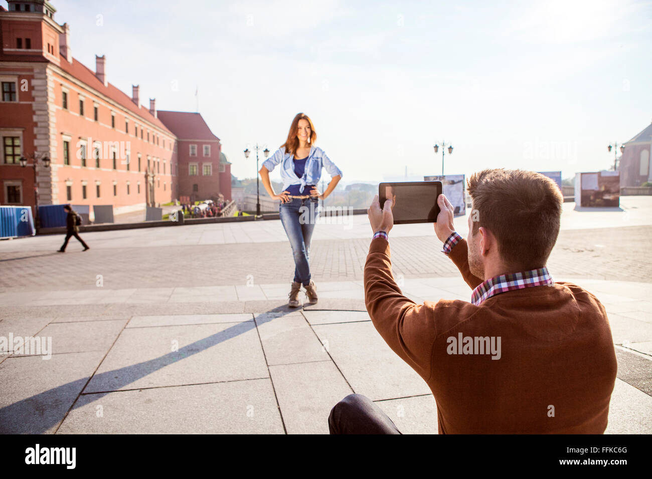 Mid adult man taking a picture of girlfriend Stock Photo