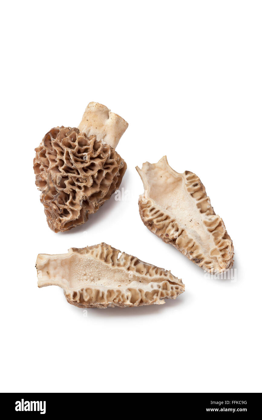 Whole and half fresh raw Morel mushroom on white background Stock Photo