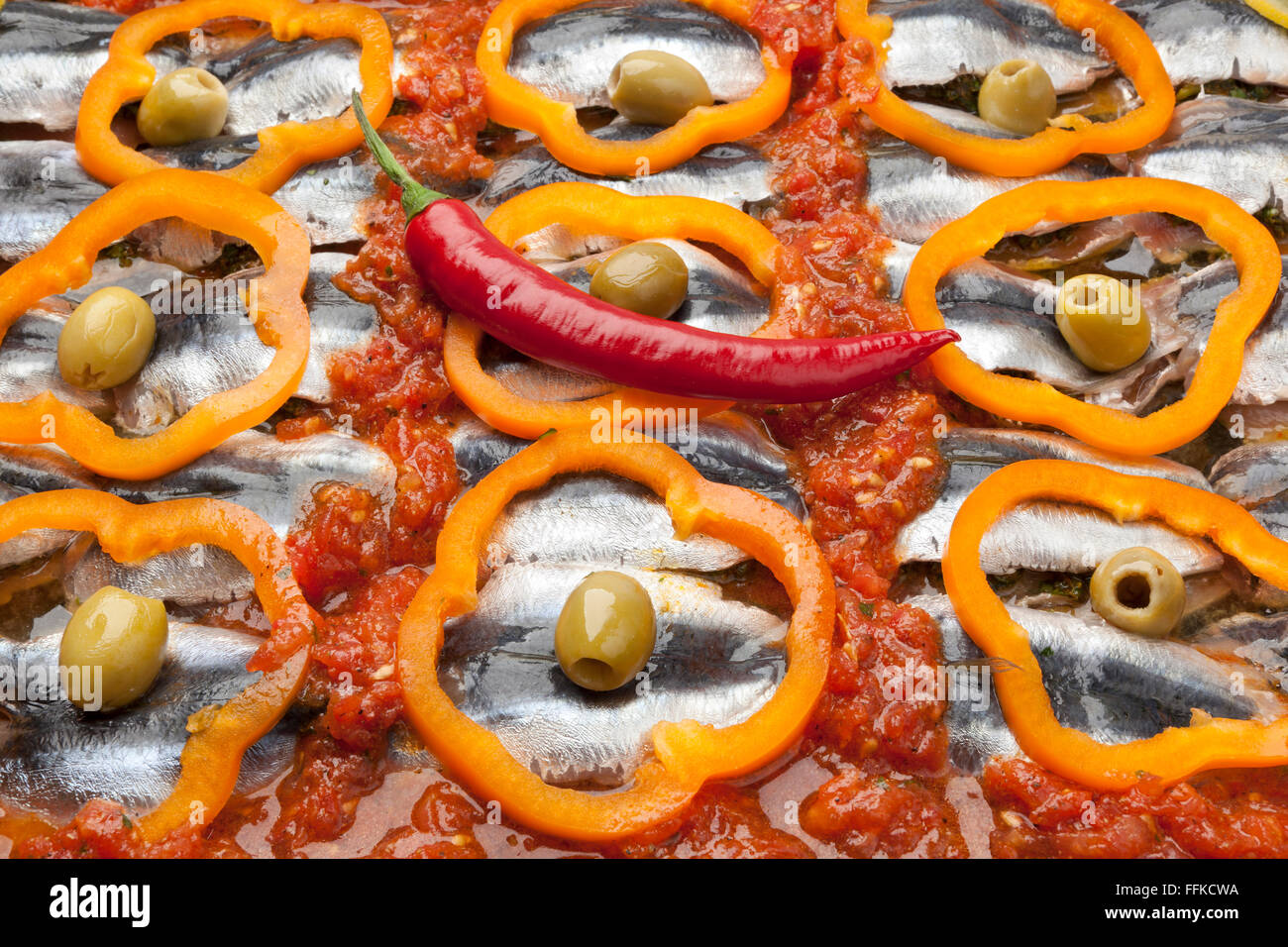 Traditional Moroccan sardine dish recipe with olives, bell peppers and chili pepper full frame Stock Photo