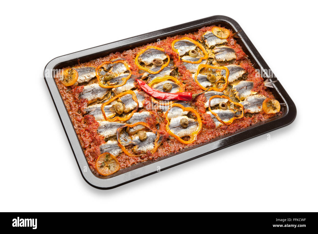 Traditional Moroccan sardine dish receipe with olives, bell peppers and chili pepper on white background Stock Photo