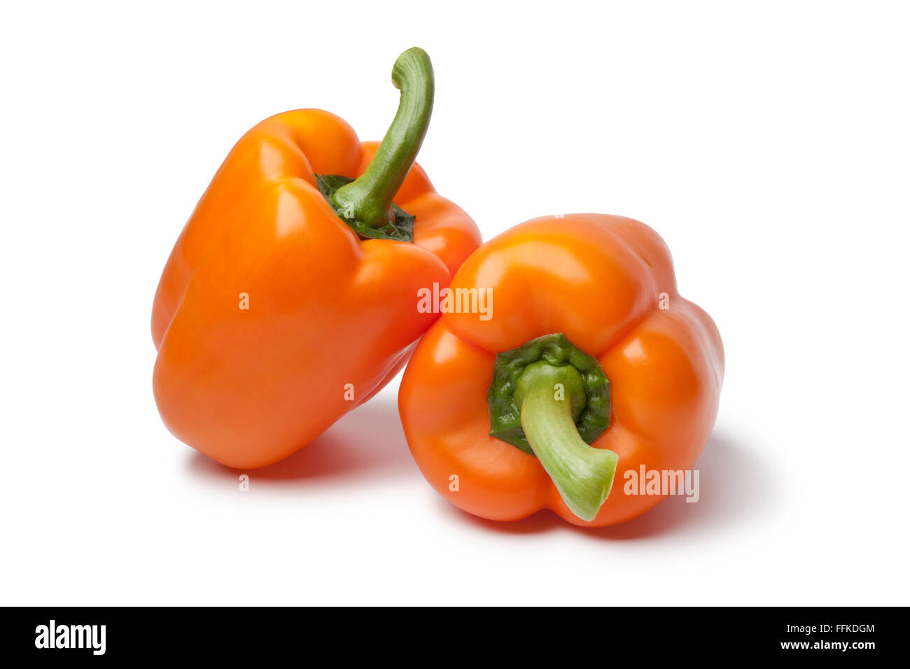 Whole fresh orange bell peppers on white background Stock Photo