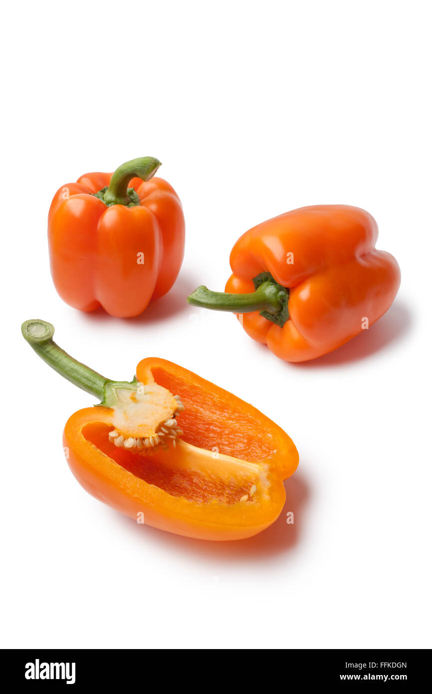Whole and half fresh orange bell peppers on white background Stock Photo
