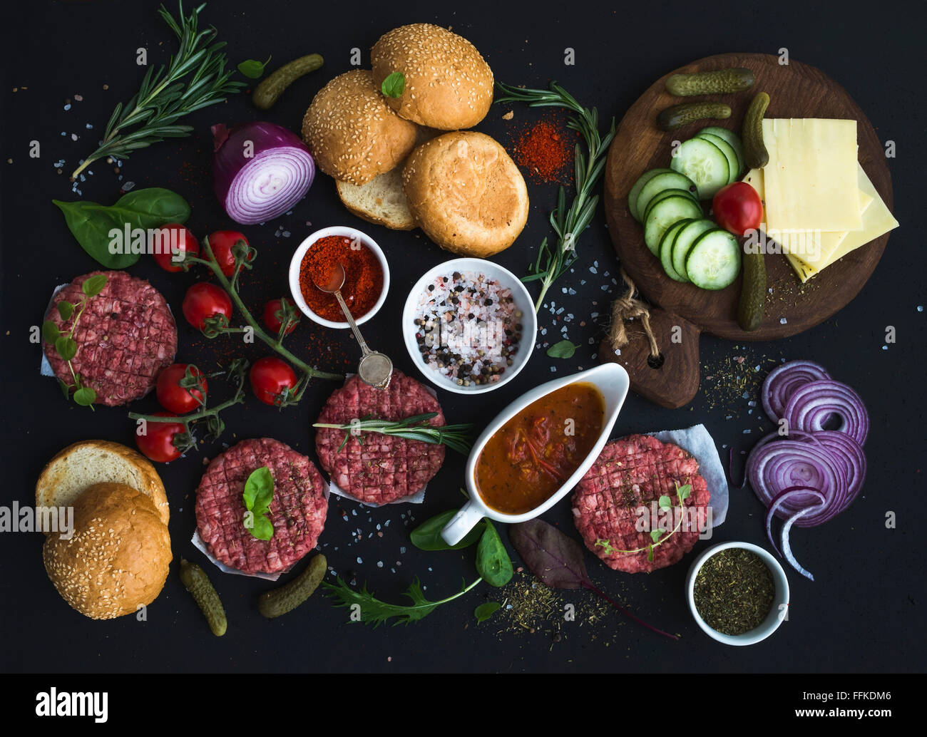 Ingredients for cooking burgers. Raw ground beef meat cutlets, buns