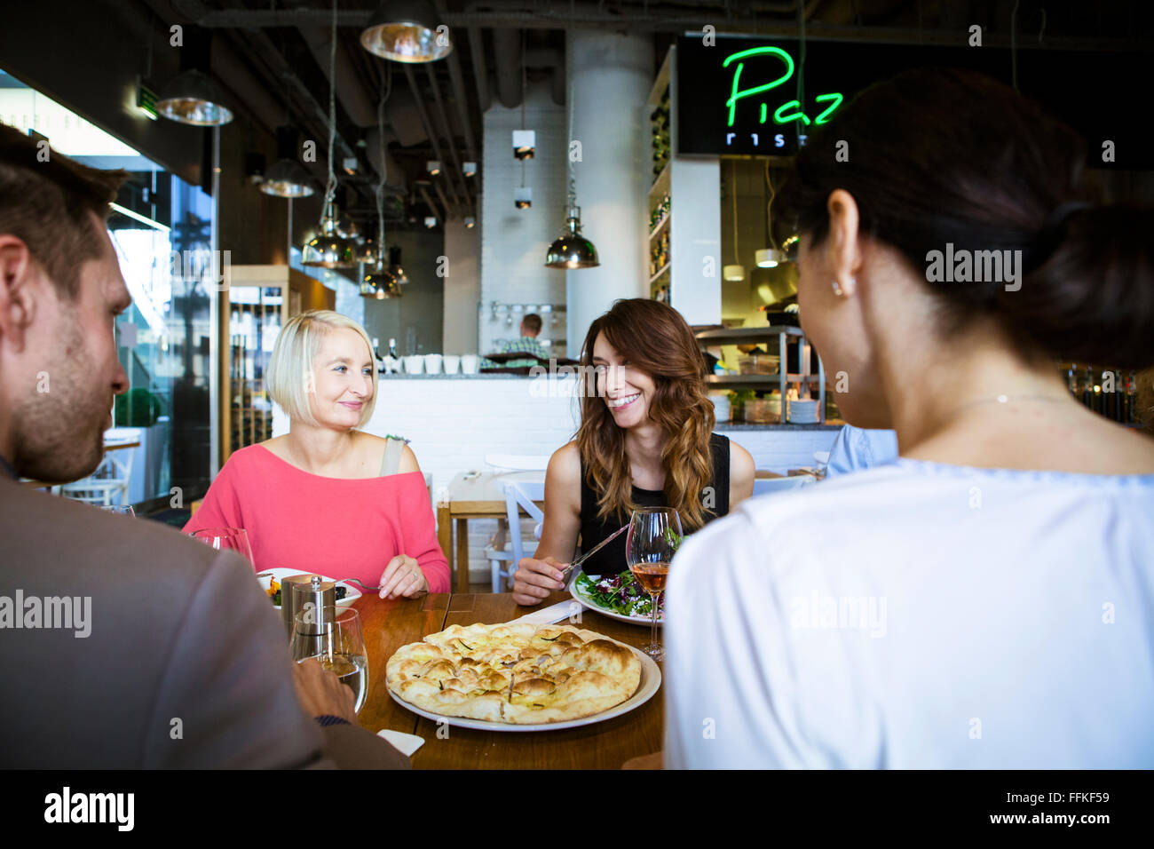 Group of friends celebrating in restaurant Stock Photo