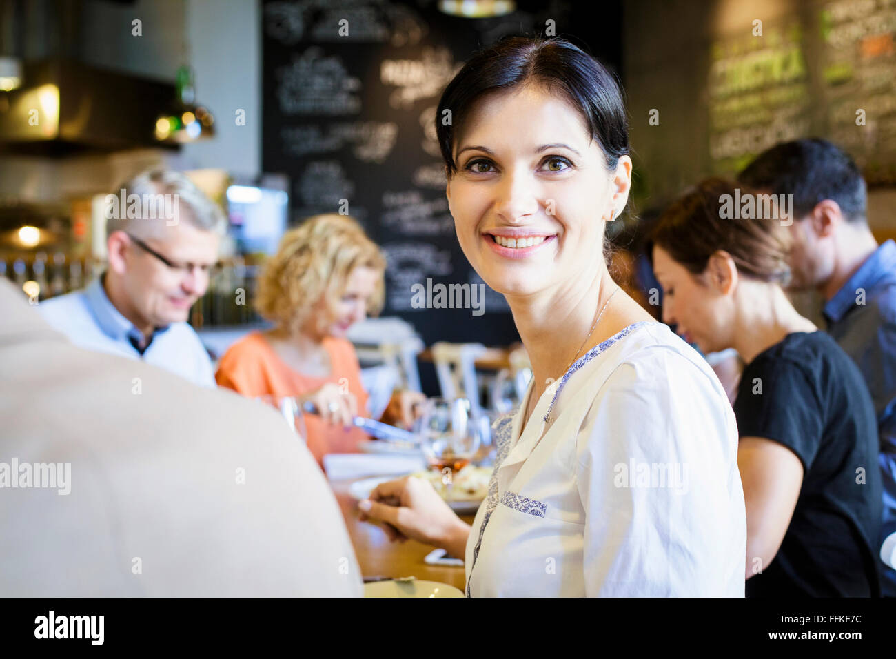 Group of friends celebrating in restaurant Stock Photo