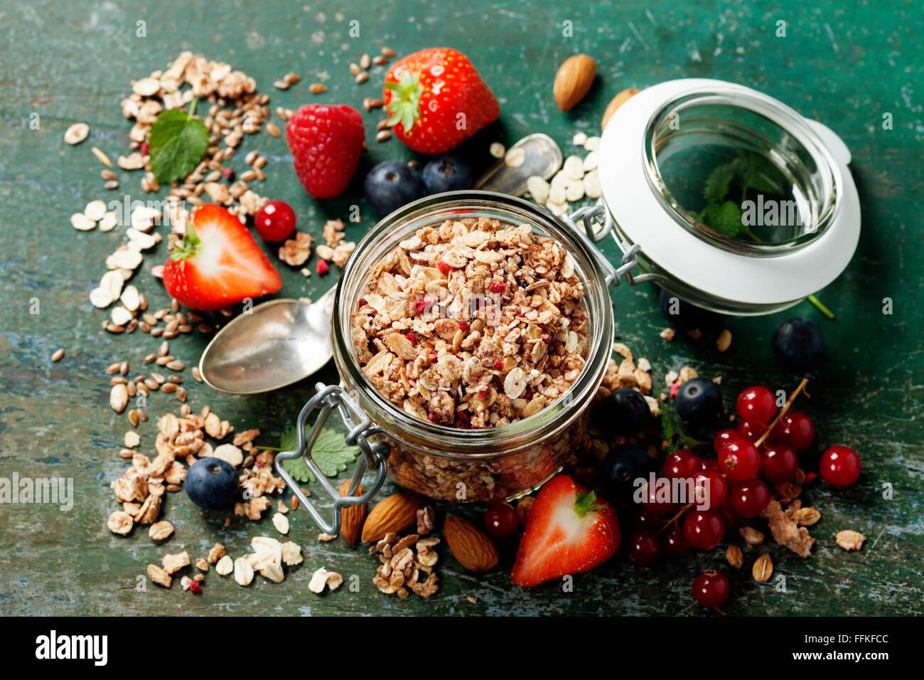 Healthy breakfast of muesli, berries with yogurt and seeds on dark background. Stock Photo