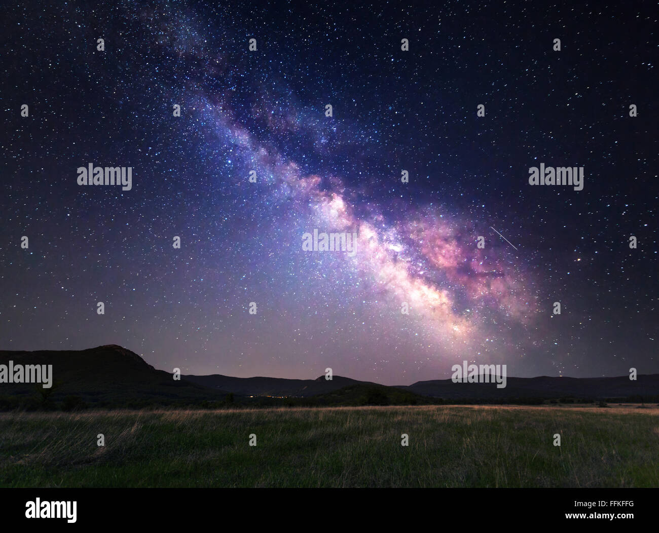 Landscape with Milky Way. Night sky with stars at mountains. Stock Photo