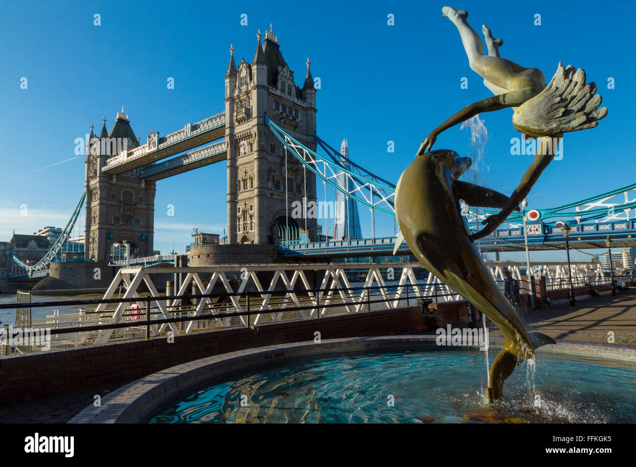 Girl with a Dolphin fountain and Tower Bridge at St Katharine's Pier, London, England Stock Photo