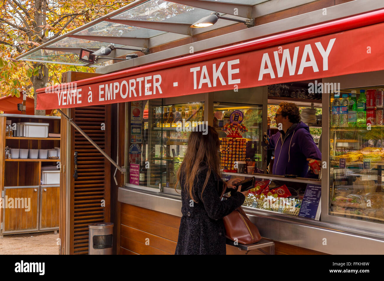 Young woman buying snacks from a take away shop Stock Photo
