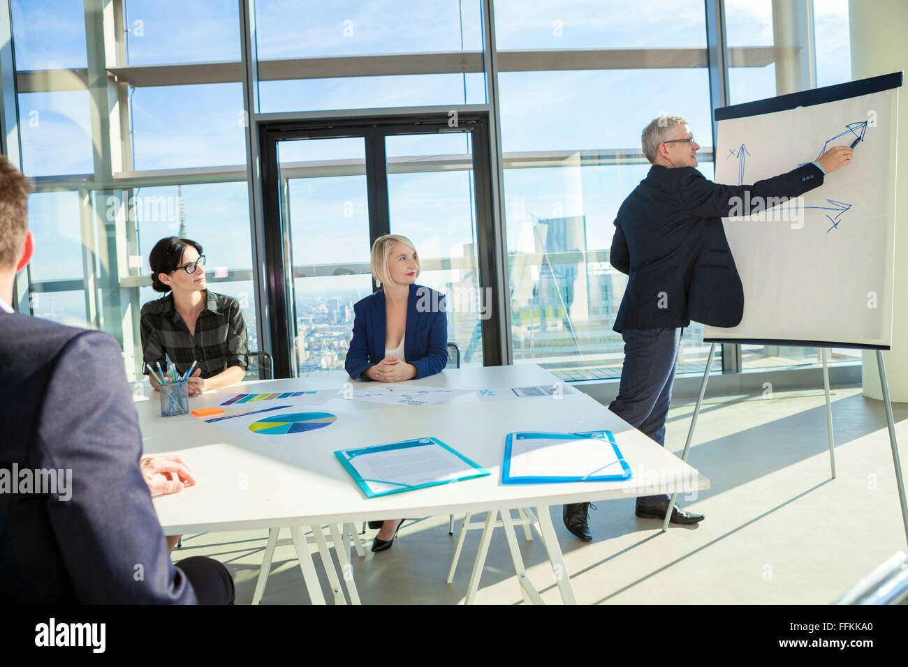 Senior architect giving presentation in business meeting Stock Photo
