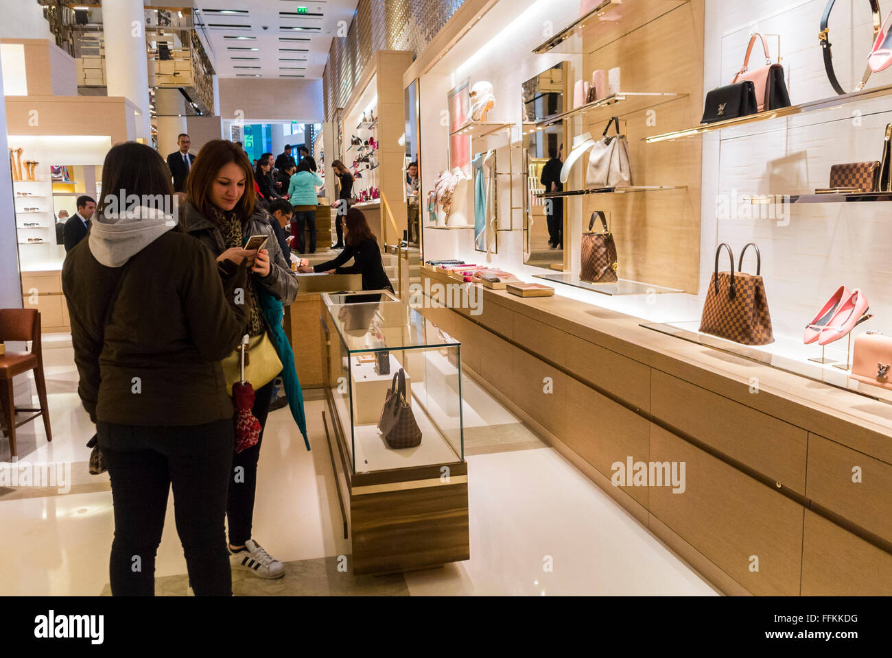 Paris, France, Chinese Women Shopping, inside Luxury Fashion Label Store, LVMH, Louis Vuitton Store, designer label, mode labels, Champs Elysees Paris shop, Bags Stock Photo