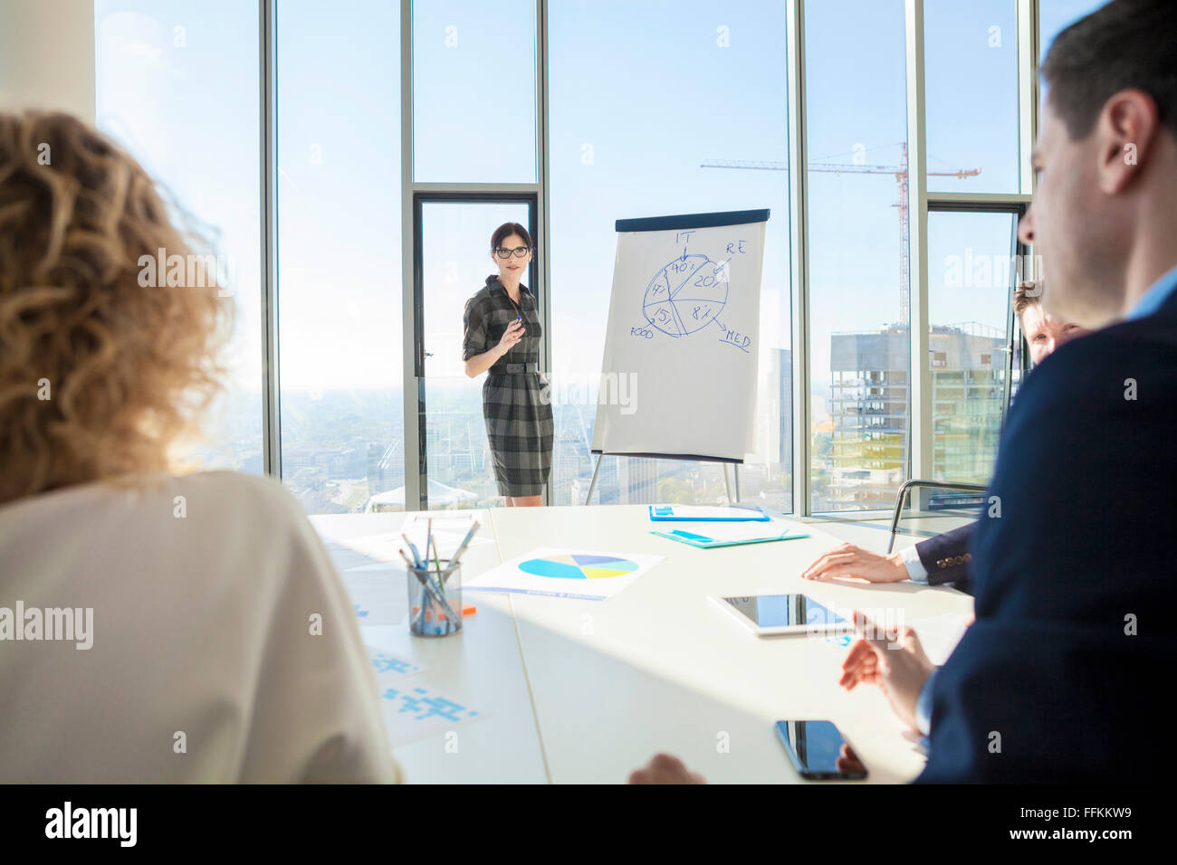 Female architect giving presentation in business meeting Stock Photo