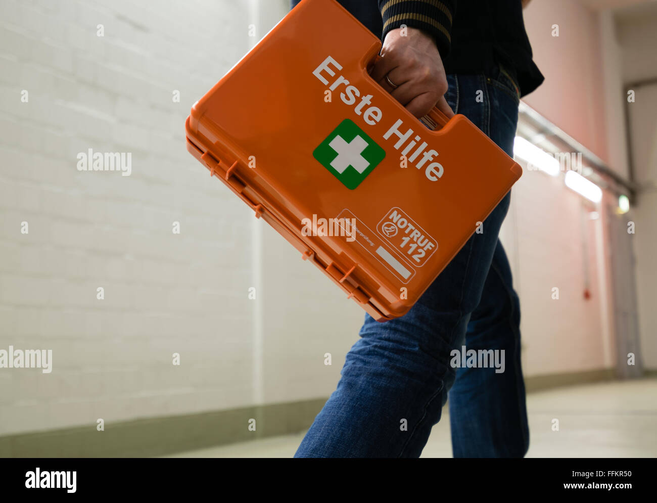 First aid after an accident at work. First responder with first aid kit, Germany. Stock Photo