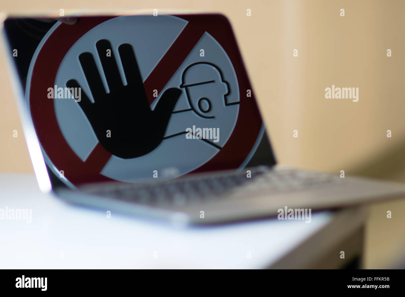 Stop sign in Notebook screen. Concept of stopping tinternet crime. Stock Photo