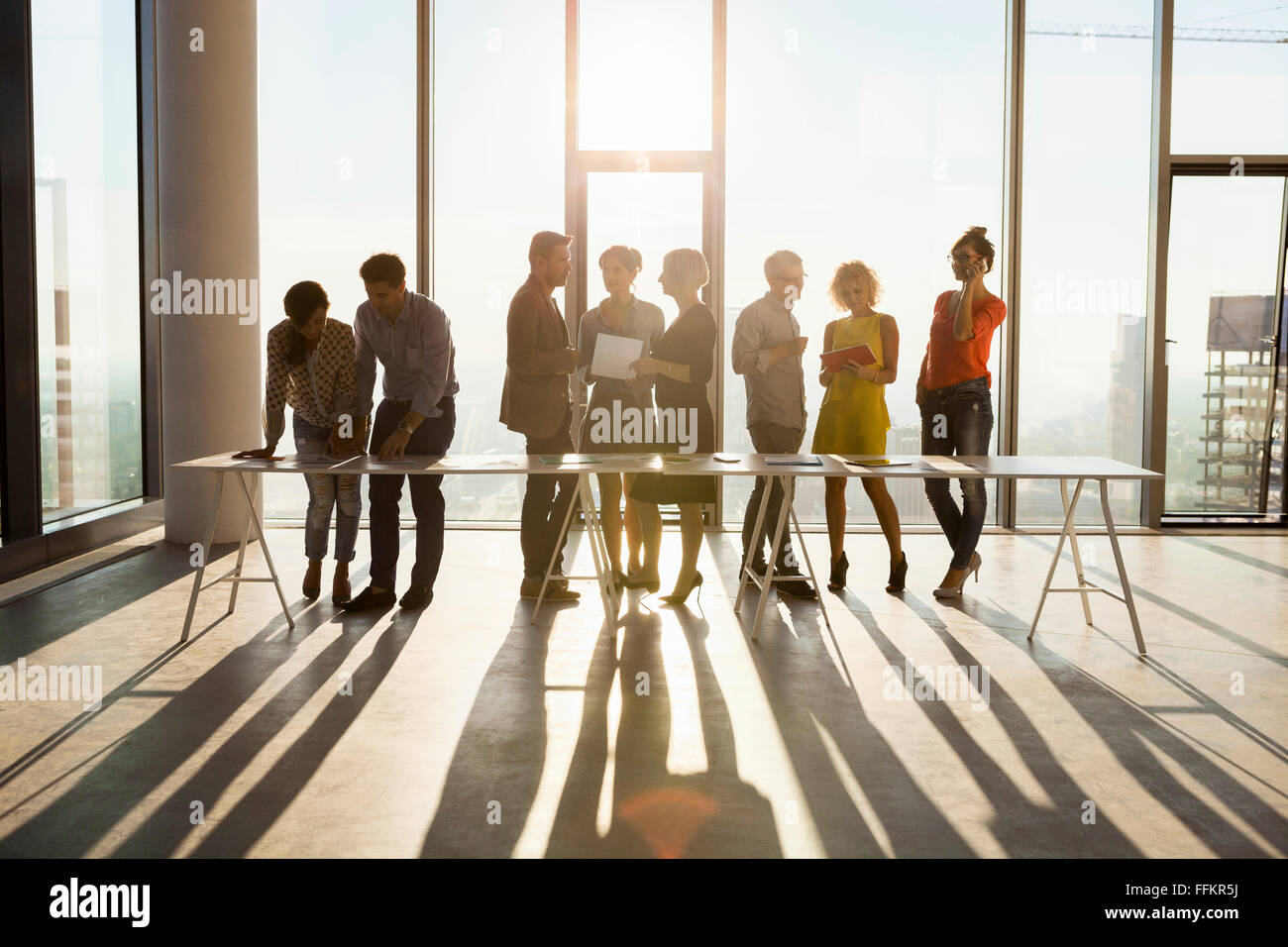 Team of architects in business meeting against urban skyline Stock Photo