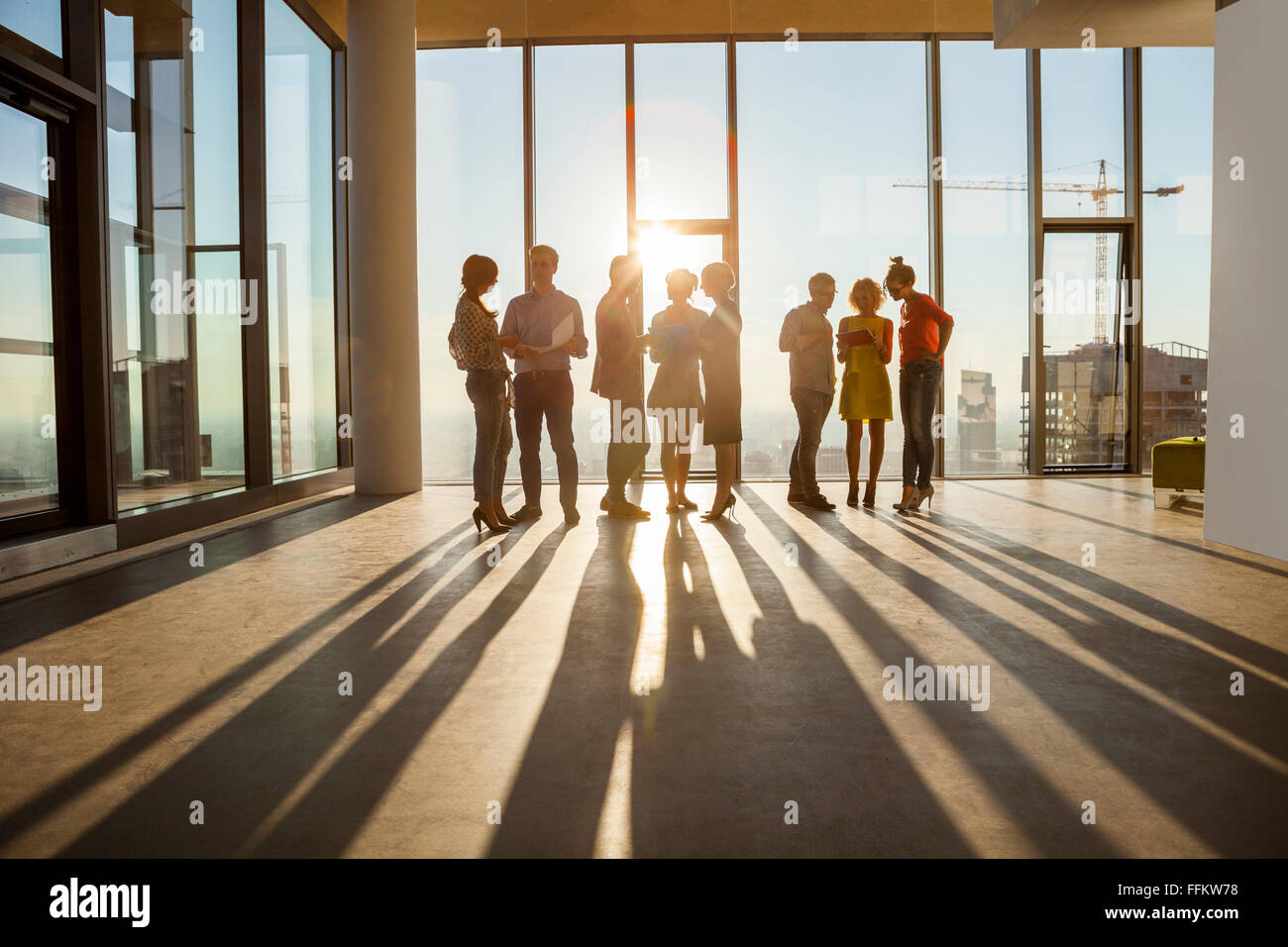 Team of architects in business meeting against urban skyline Stock Photo