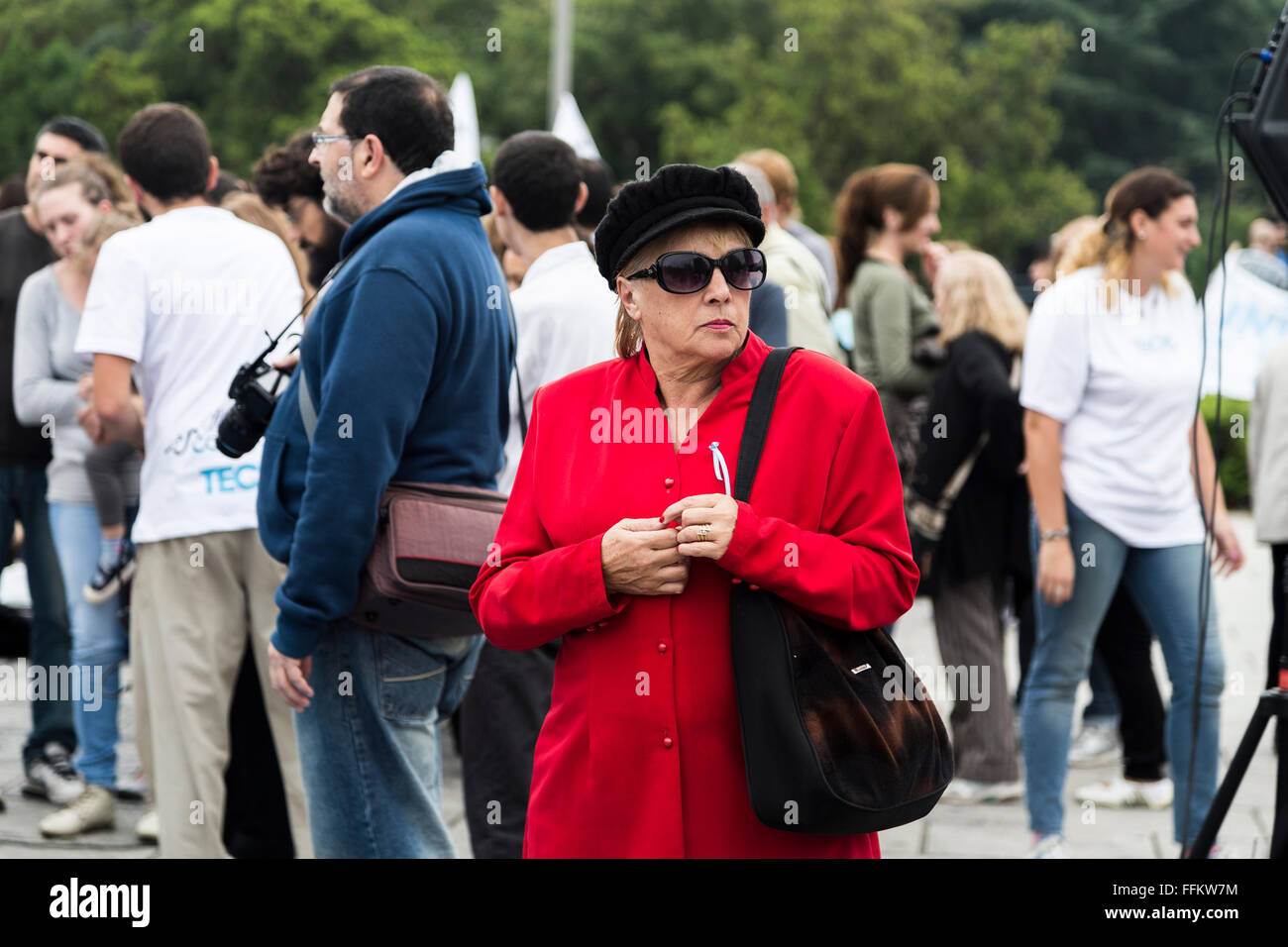 An old woman in red dress in a march that took place in La Plata, Argentina. About a flood that occurred in the year 2013 Stock Photo
