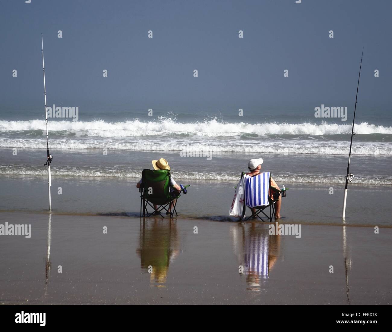 Fishermen on the beach, waiting for a bite Stock Photo