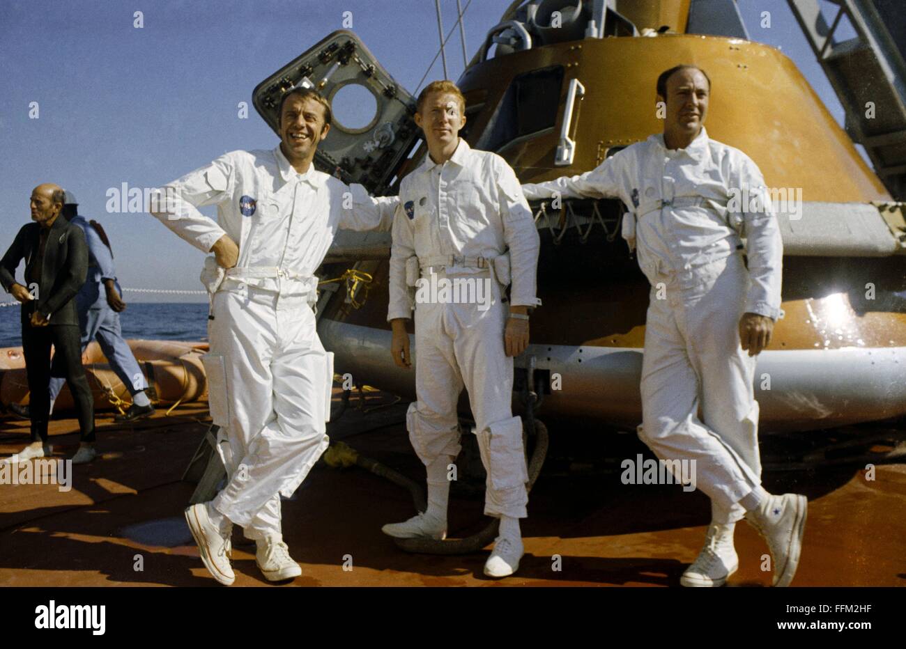 NASA Apollo 14 astronauts Alan B. Shepard Jr. (left), commander, and Edgar D. Mitchell, lunar module pilot, right, and Stuart A. Roosa, command module pilot, center, relax on the Command Module retriever during egress training in the Gulf of Mexico October 24, 1970 in Florida. Stock Photo