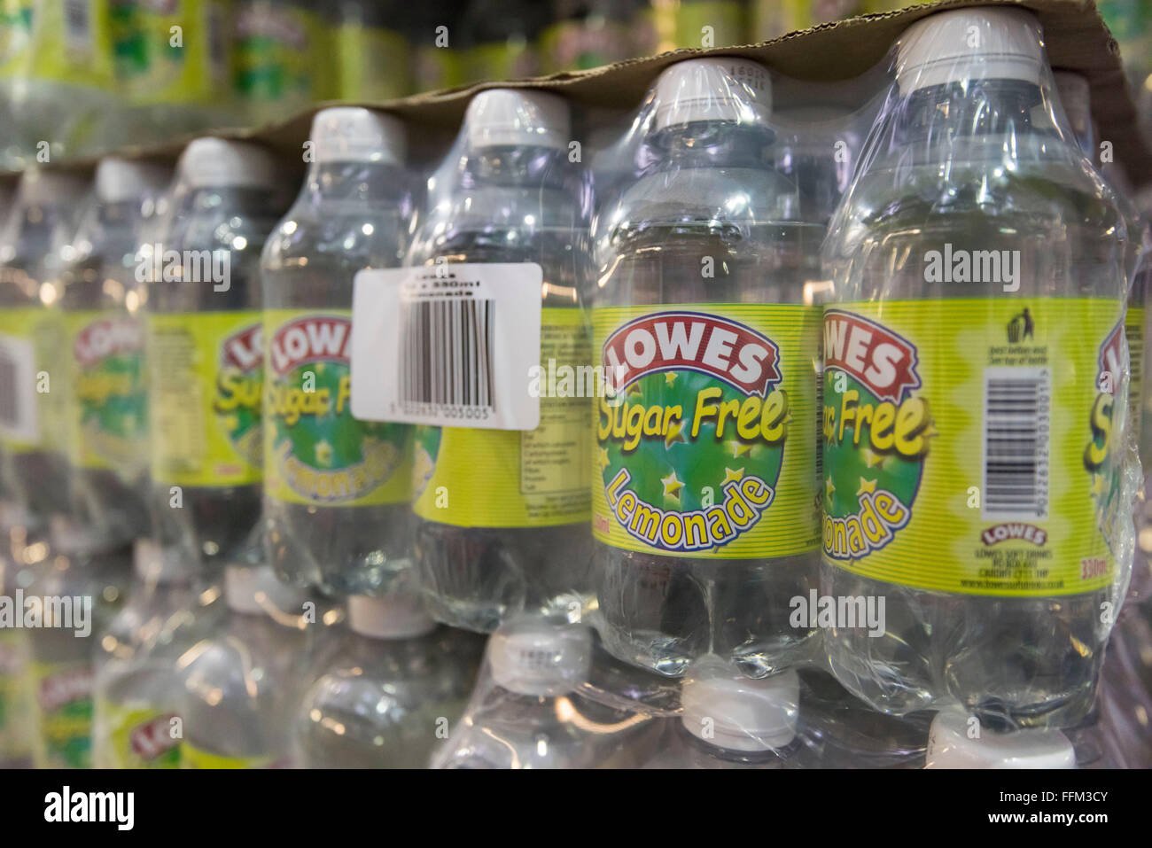 Bottles of Lowes sugar free lemonade soft drink wrapped in cellophane and stacked in a warehouse. Stock Photo