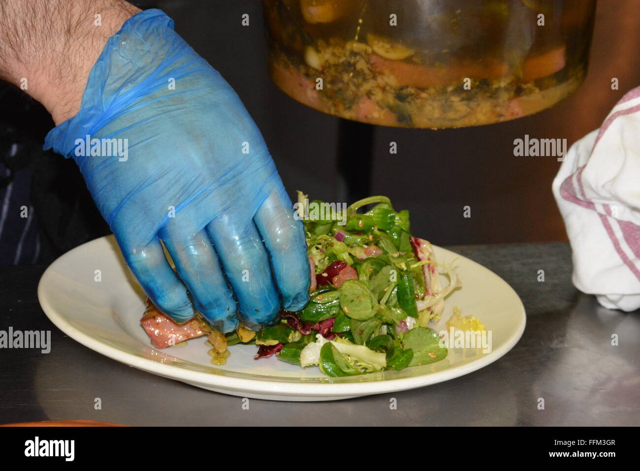Owner prepares food at Sanpa Tapas Bar & Restaurant in Wokingham, town centre. Berkshire, UK. Charles Dye / Alamy Live News Stock Photo