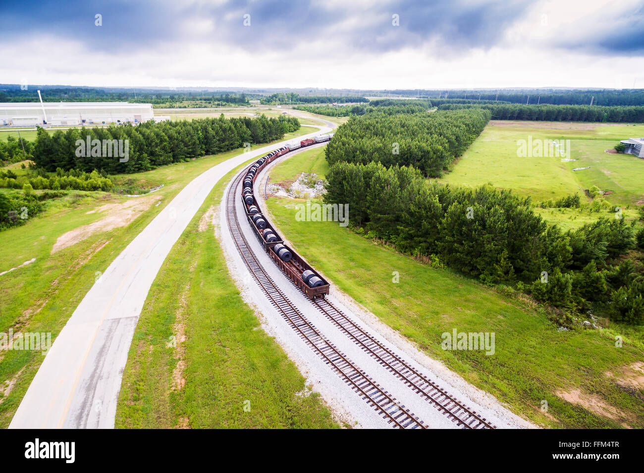 Aerial view - closer - steel coils in rail cars on train tracks in Alabama Stock Photo