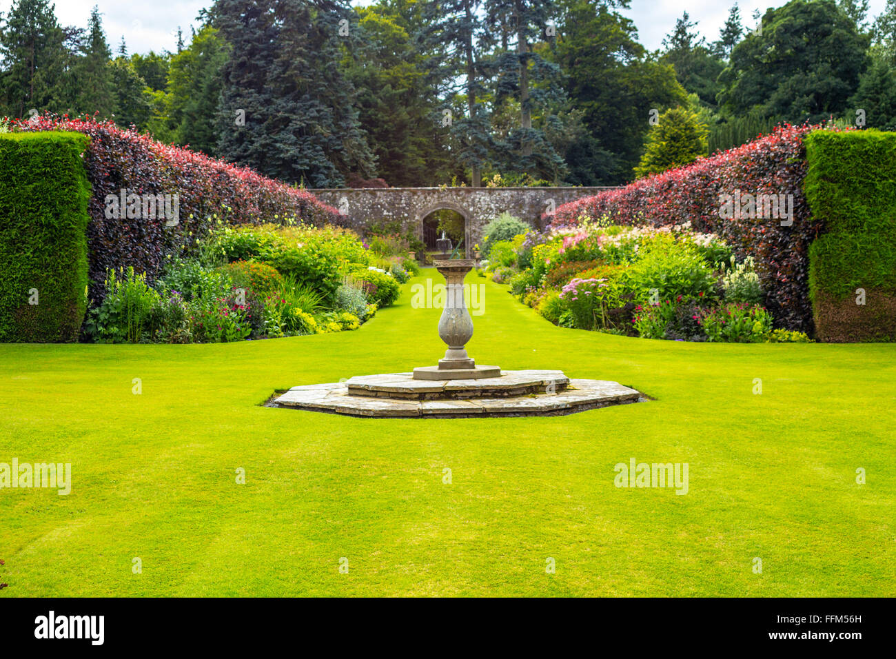 Beautiful walled, victorian garden with variety of blooming flowers and