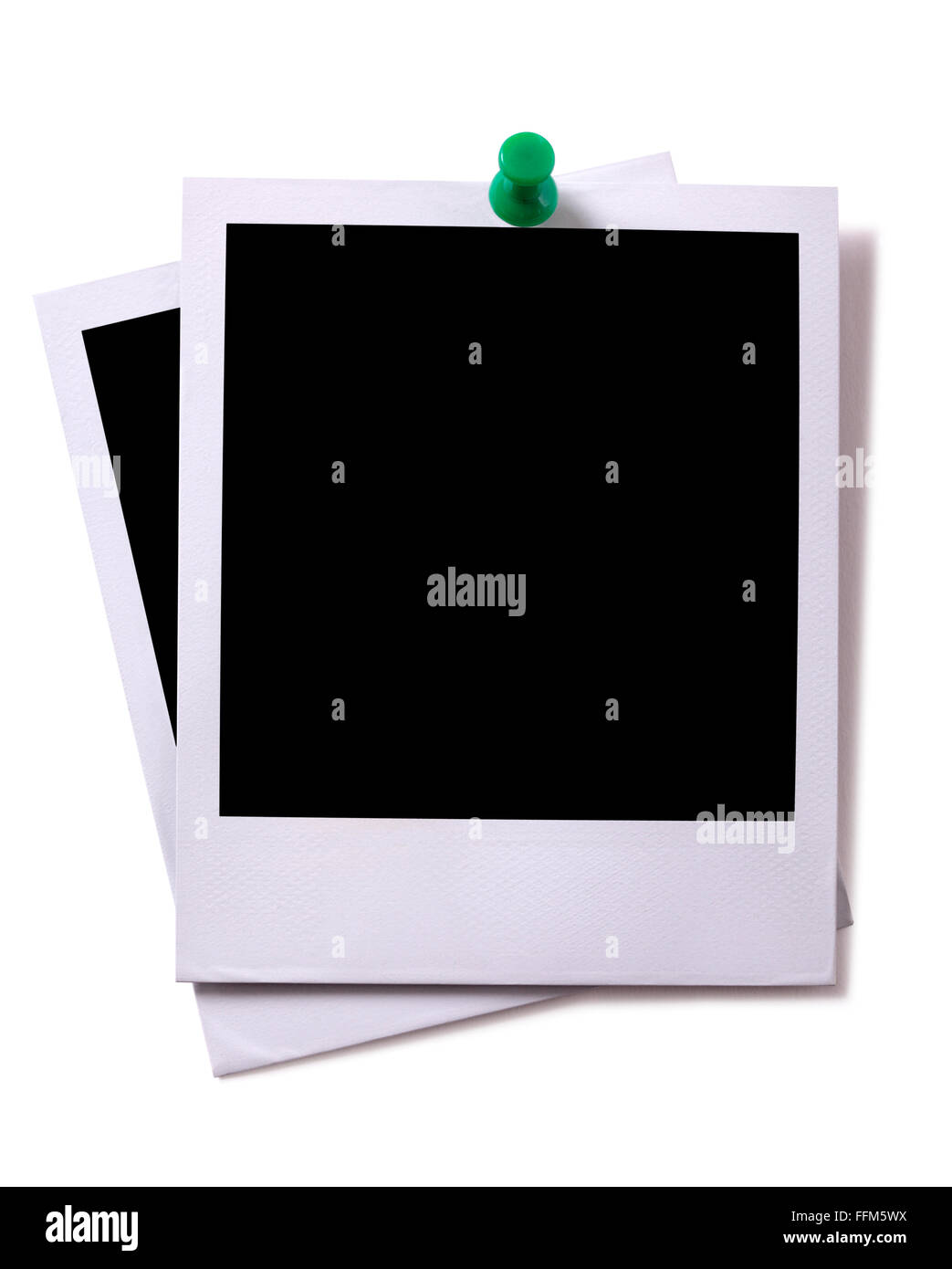 Two blank polaroid instant camera photo prints with green pushpin