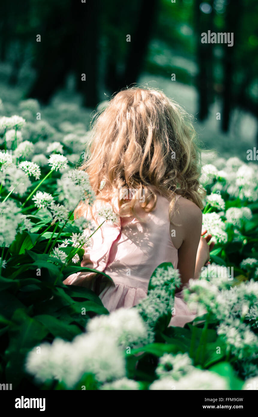 blond mysterious fairy in green woods rear view Stock Photo - Alamy