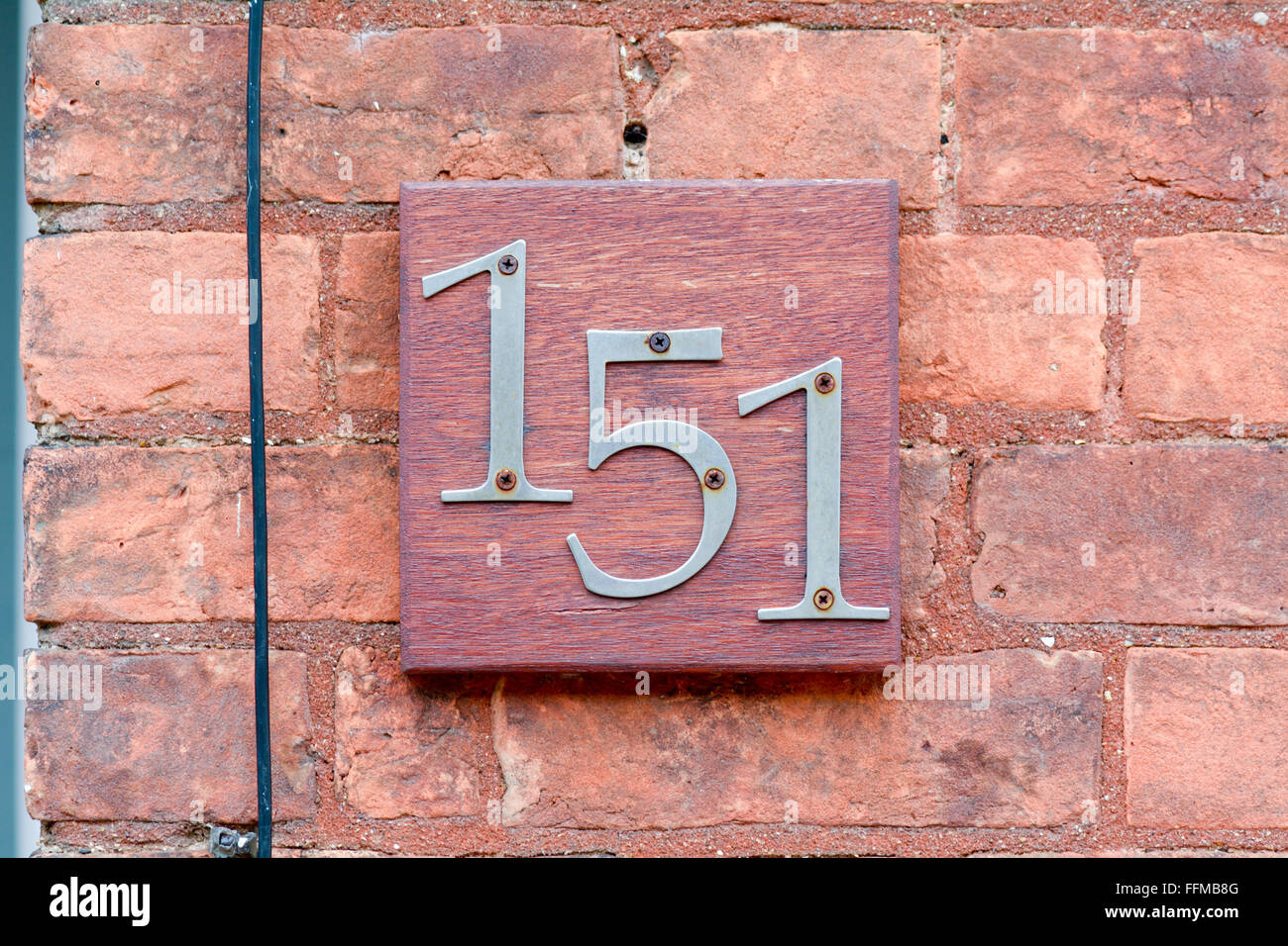 House number 151 sign on wall Stock Photo Alamy