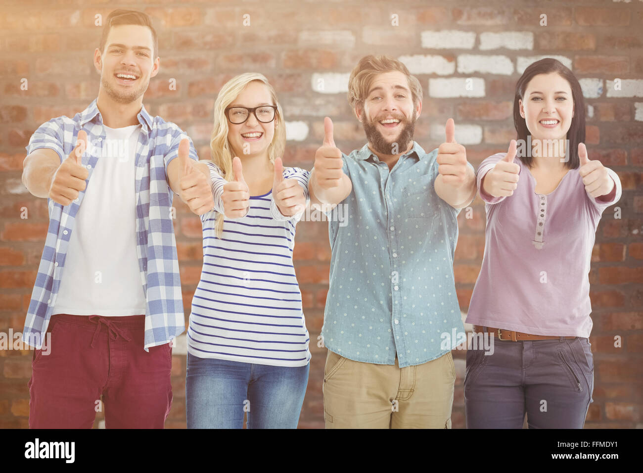 Composite image of portrait of smiling business people with thumbs up Stock Photo