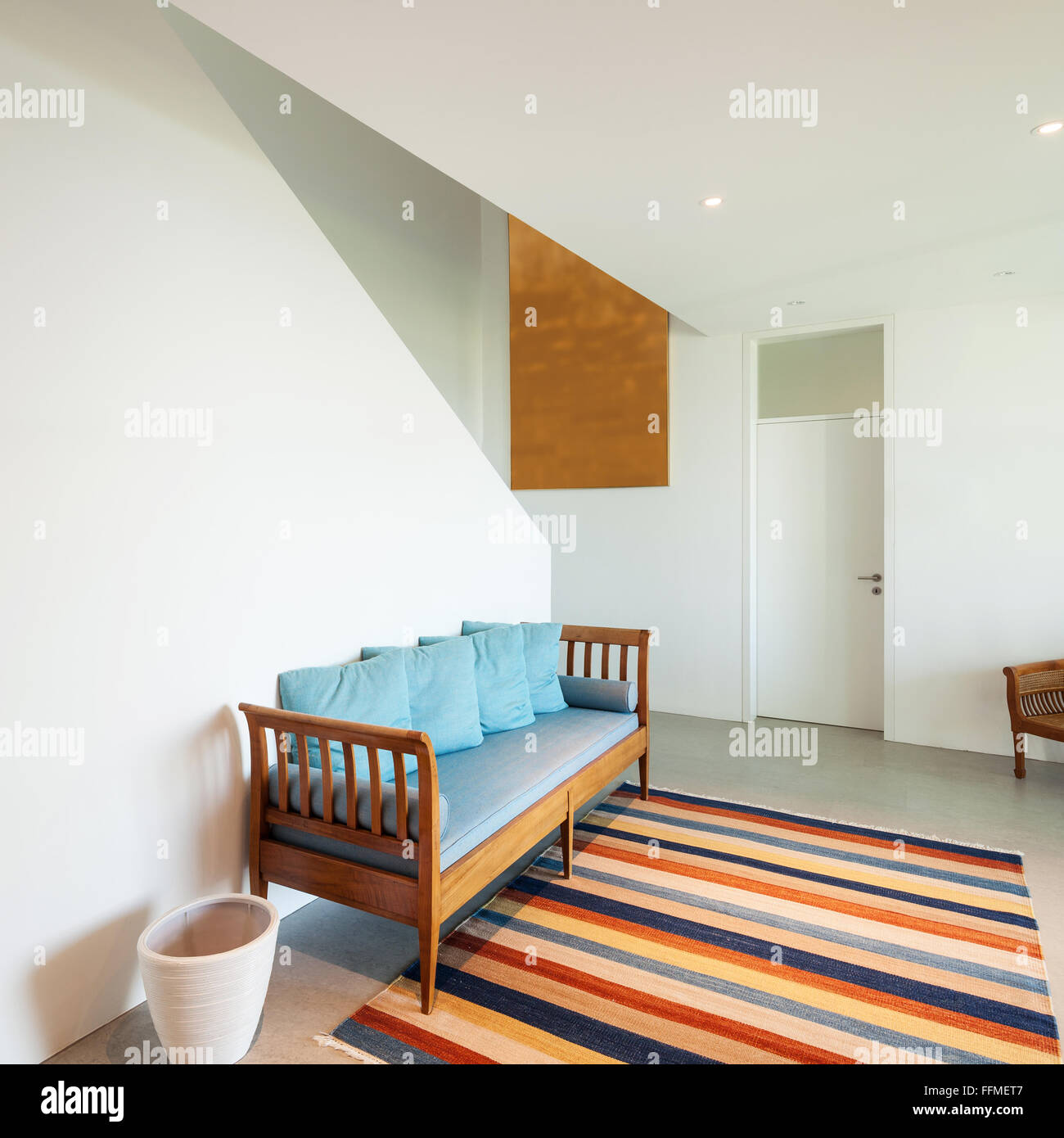 Interior of a modern house, hall with divan and striped rug Stock Photo ...