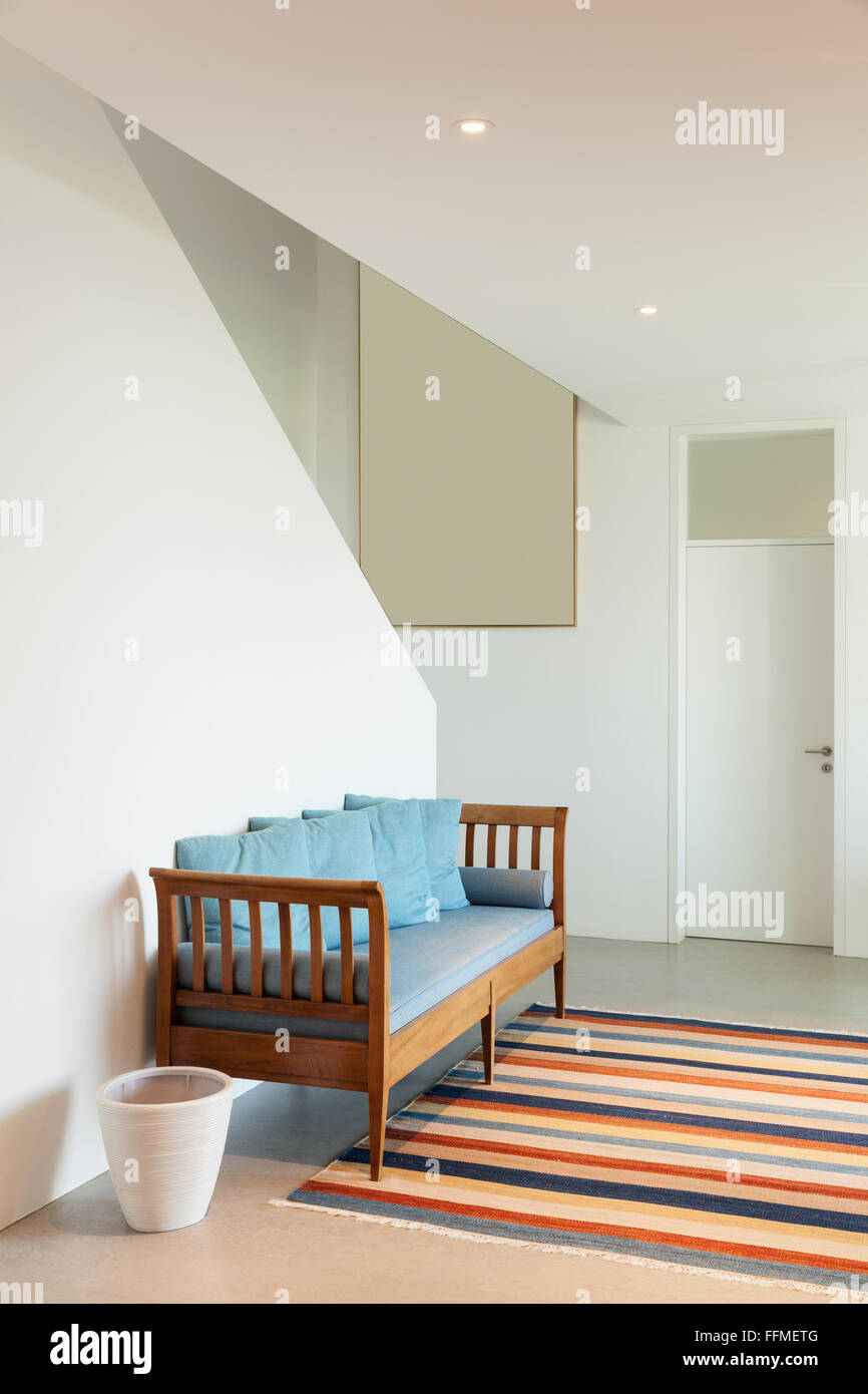 Interior of a modern house, hall with divan and striped rug Stock Photo ...