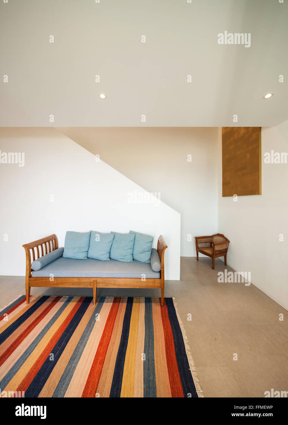 Interior of a modern house, hall with divan and striped rug Stock Photo ...