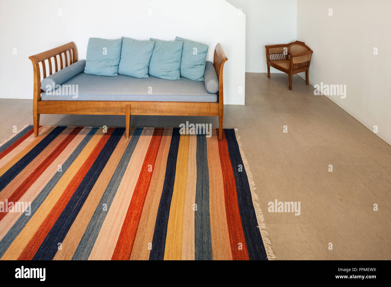 Interior of a modern house, hall with divan and striped rug Stock Photo ...