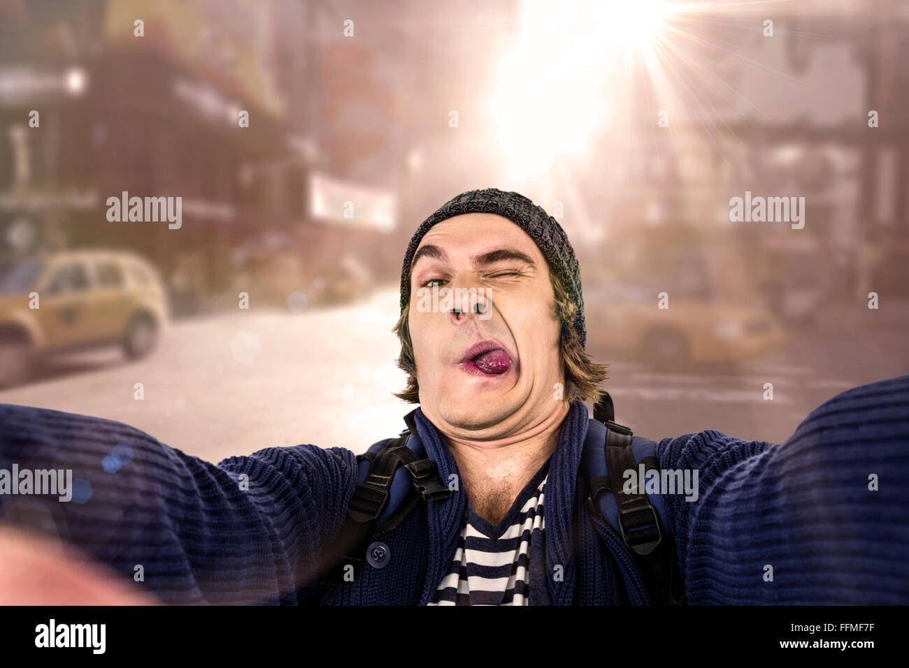 Composite image of hipster holding camera and grimacing Stock Photo