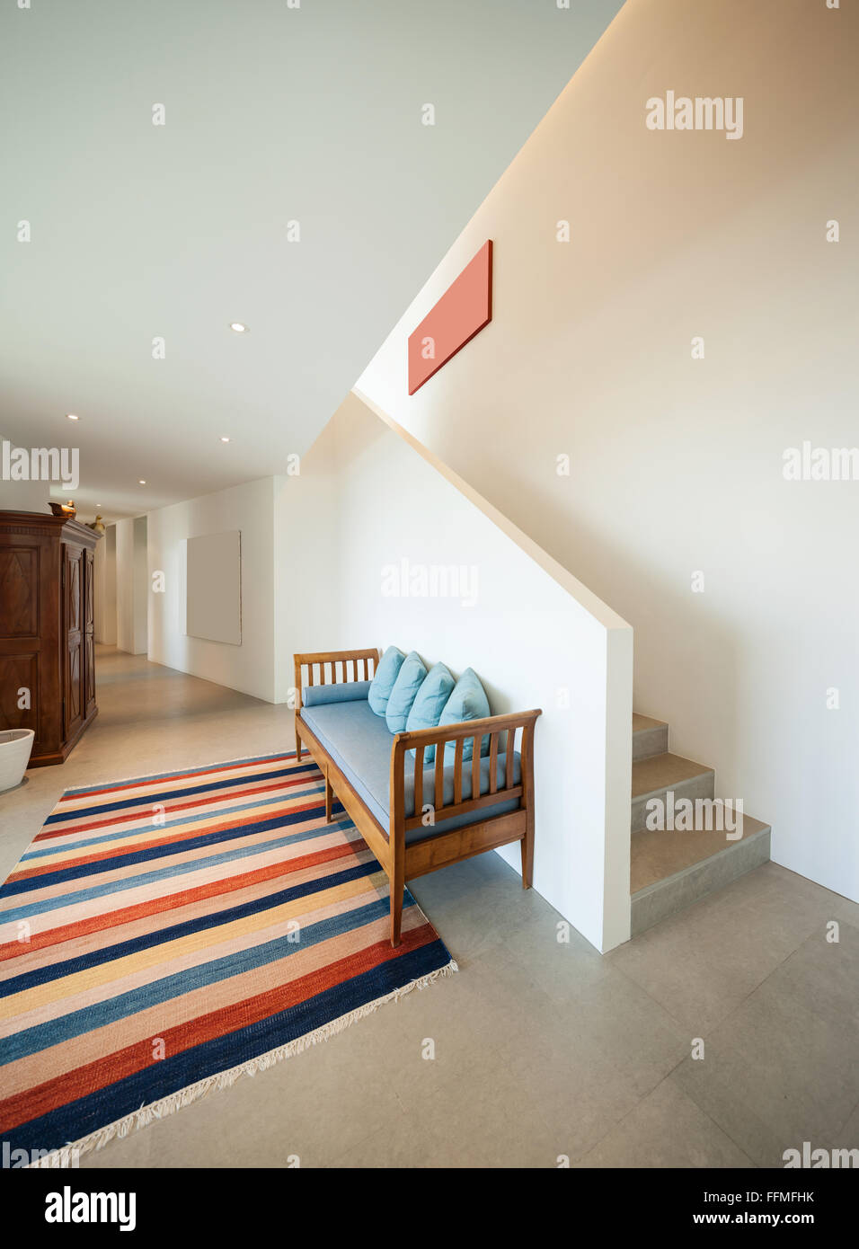 Interior of a modern house, hall with divan and striped rug Stock Photo ...