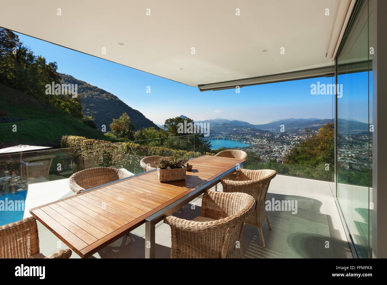 beautiful veranda with wooden table and wicker chairs,  panoramic view Stock Photo