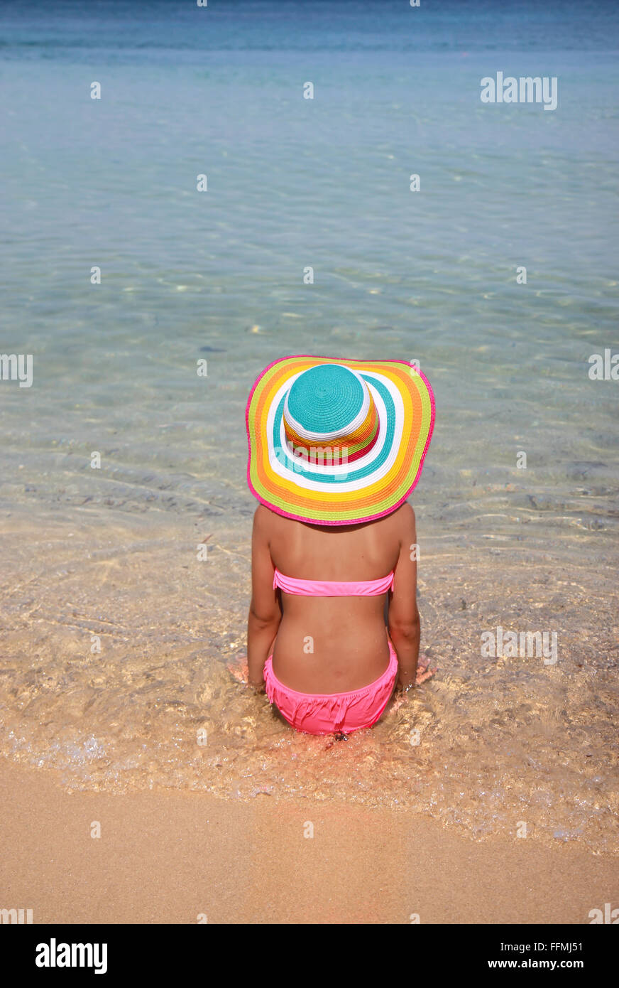 Girl with colorful hat on the beach Stock Photo Alamy