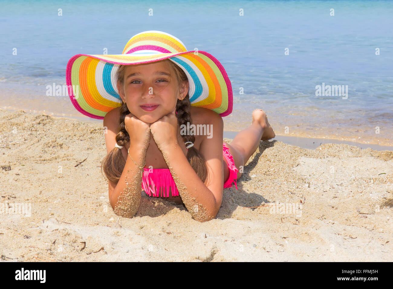 Girl with colorful hat on the beach Stock Photo Alamy