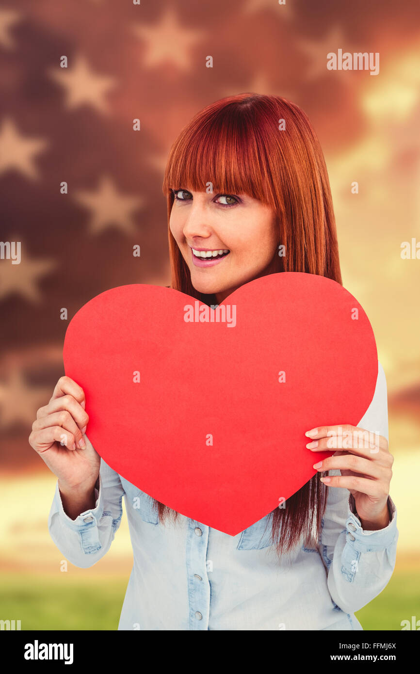 Composite image of attractive hipster woman behind a red heart Stock Photo