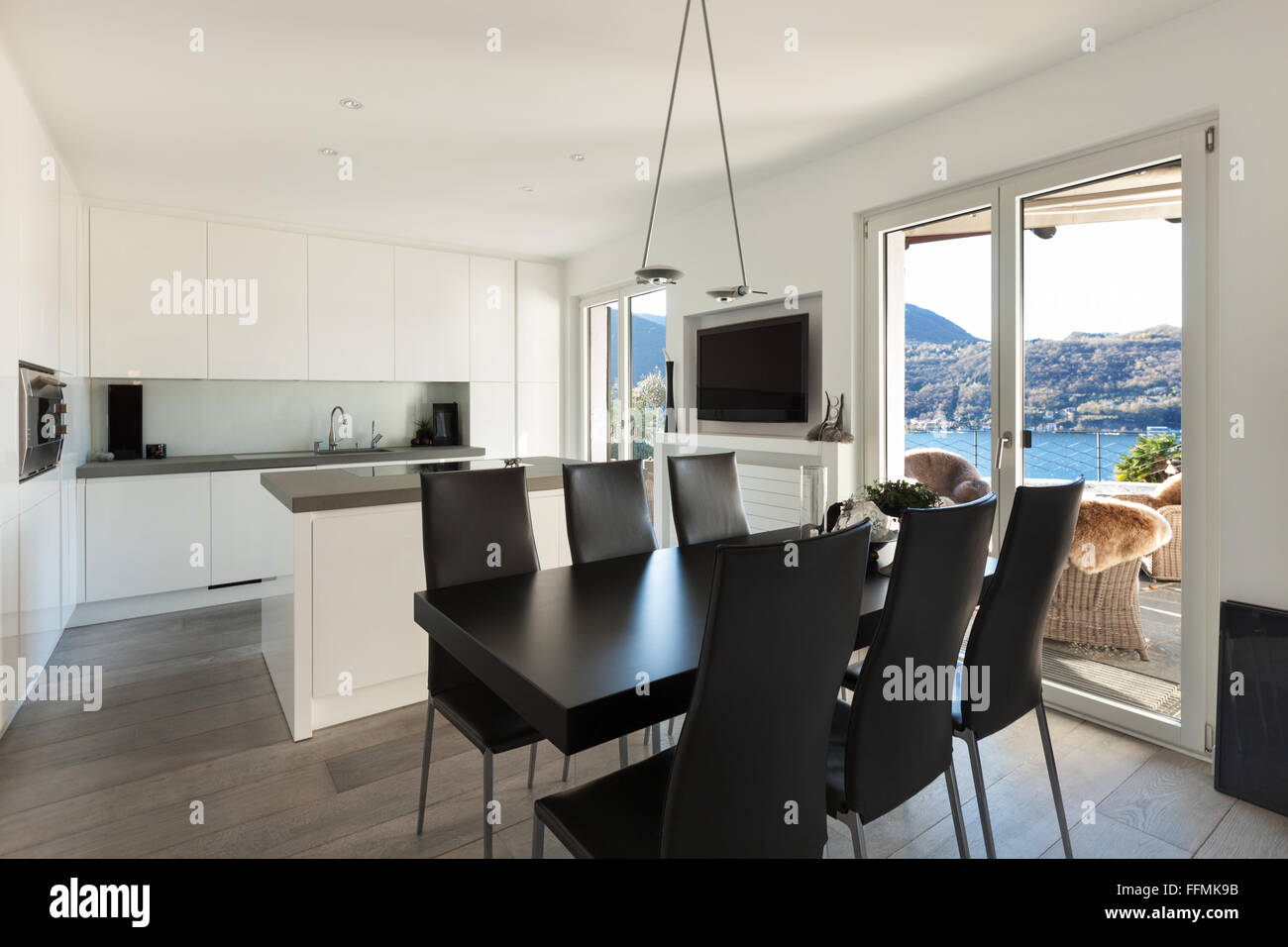 Interior of house, modern kitchen with black dining table Stock Photo ...