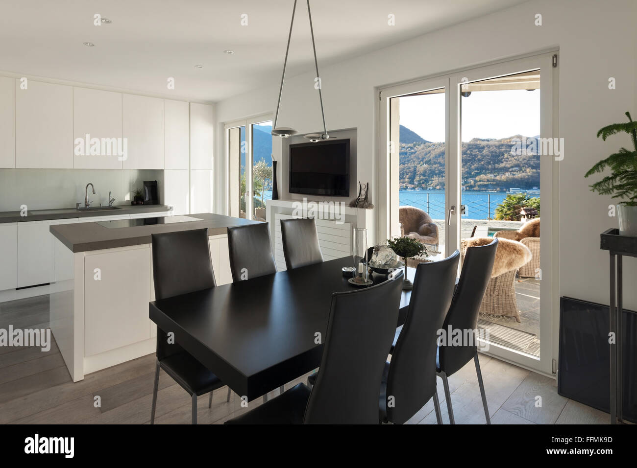 Interior of house, modern kitchen with black dining table Stock Photo ...