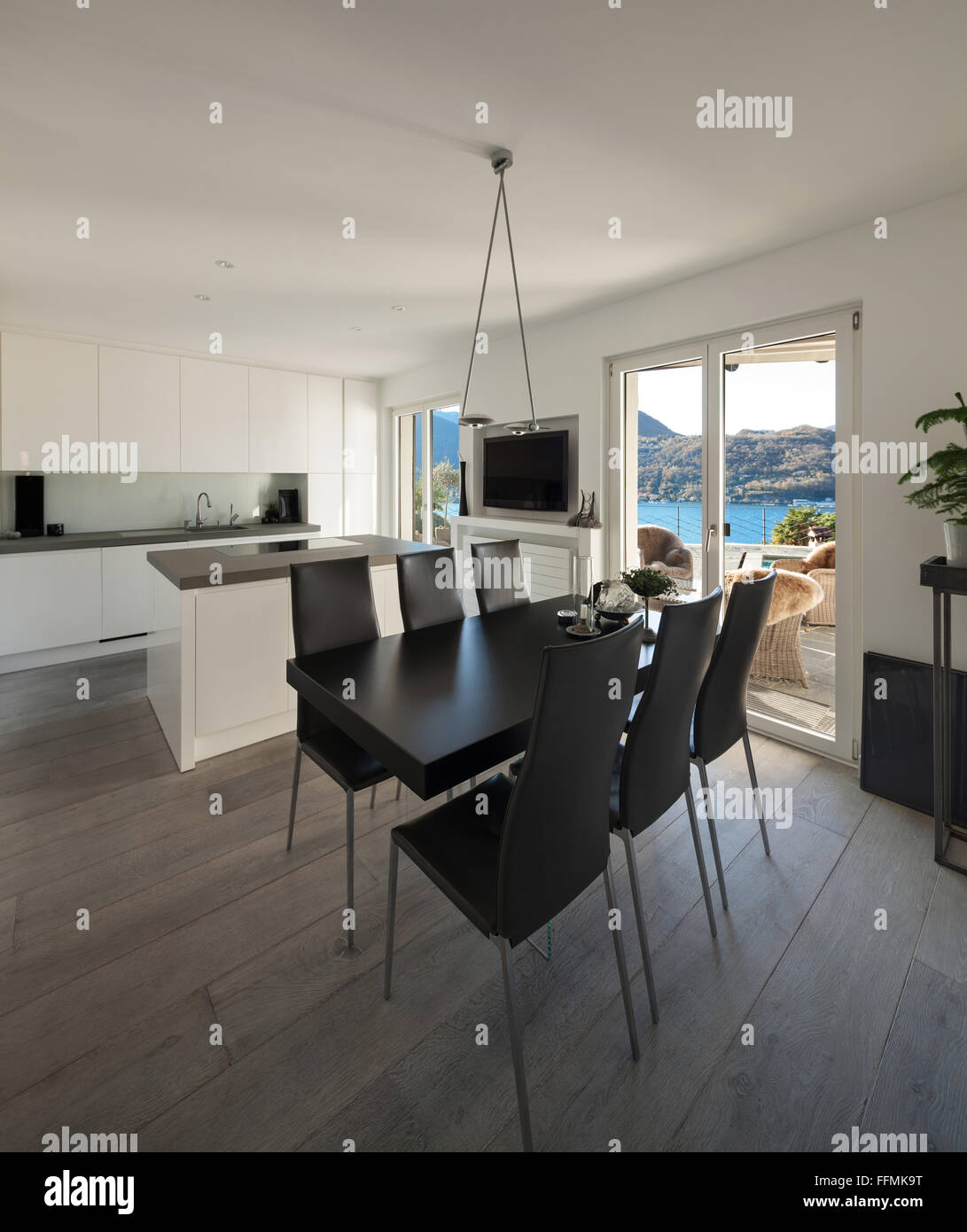 Interior of house, modern kitchen with black dining table Stock Photo ...