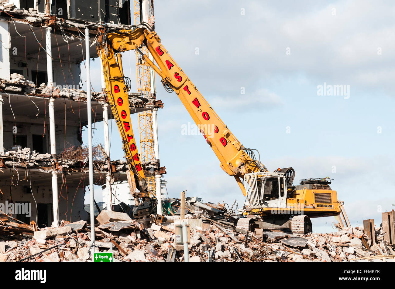 High reach excavator being used to demolish a building. Stock Photo