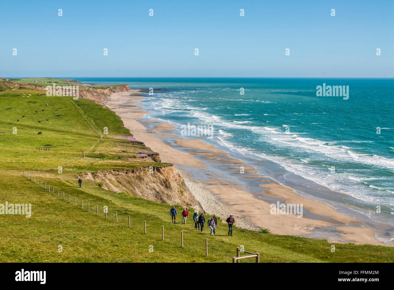 Group of hiker at a southern coastal walkway along the coastline of the Isle of Wight, South England Stock Photo