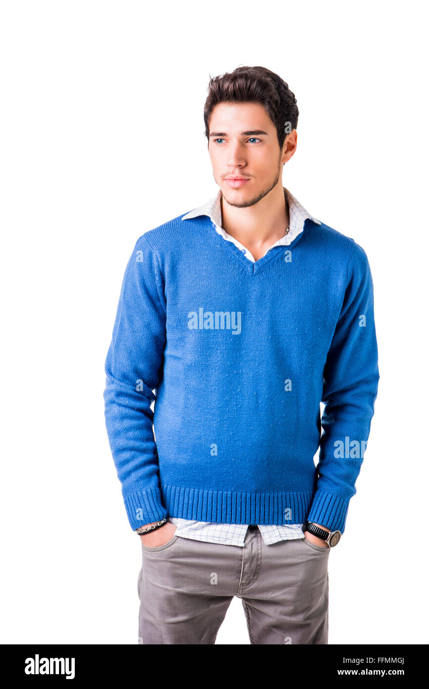 Smiling cool young man with wool sweater on white background looking at ...