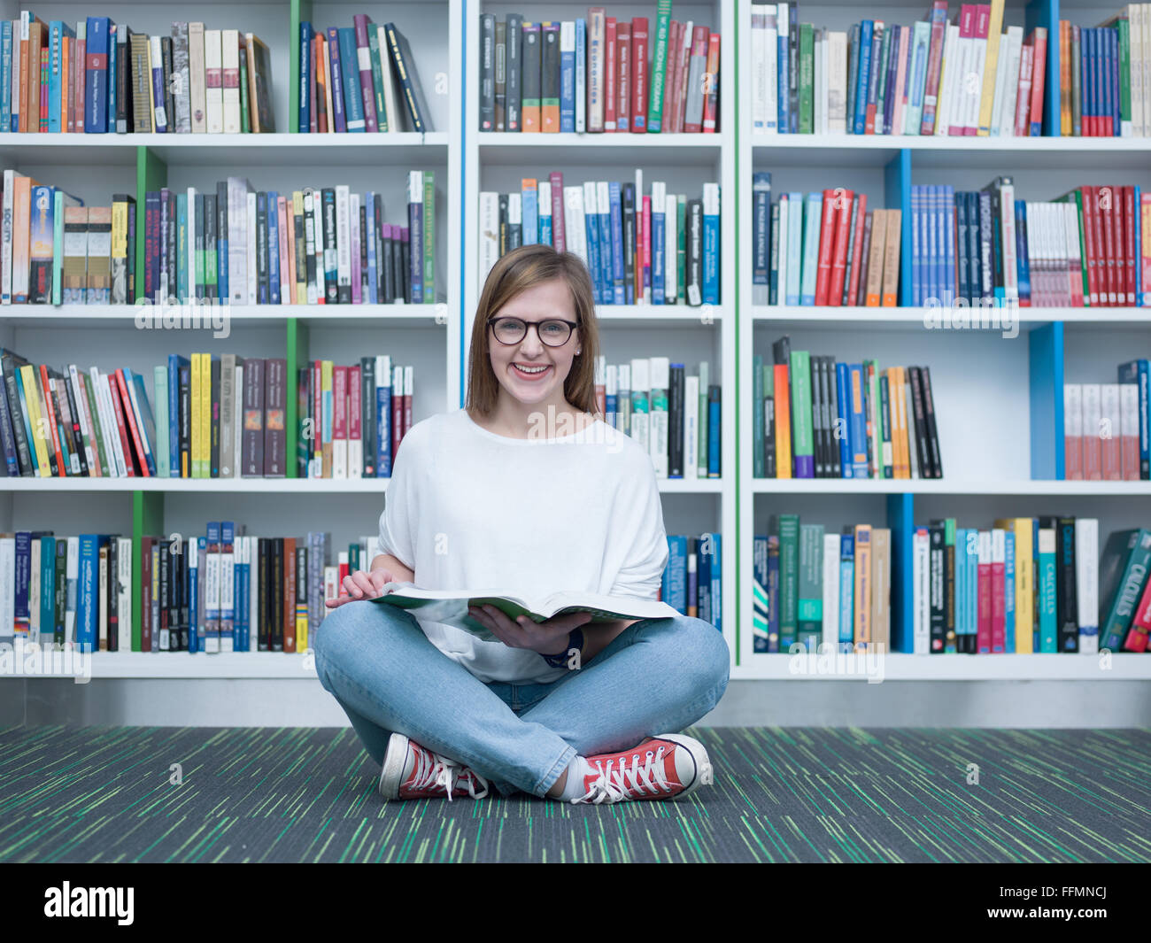 student girl in collage school library reading book Stock Photo - Alamy