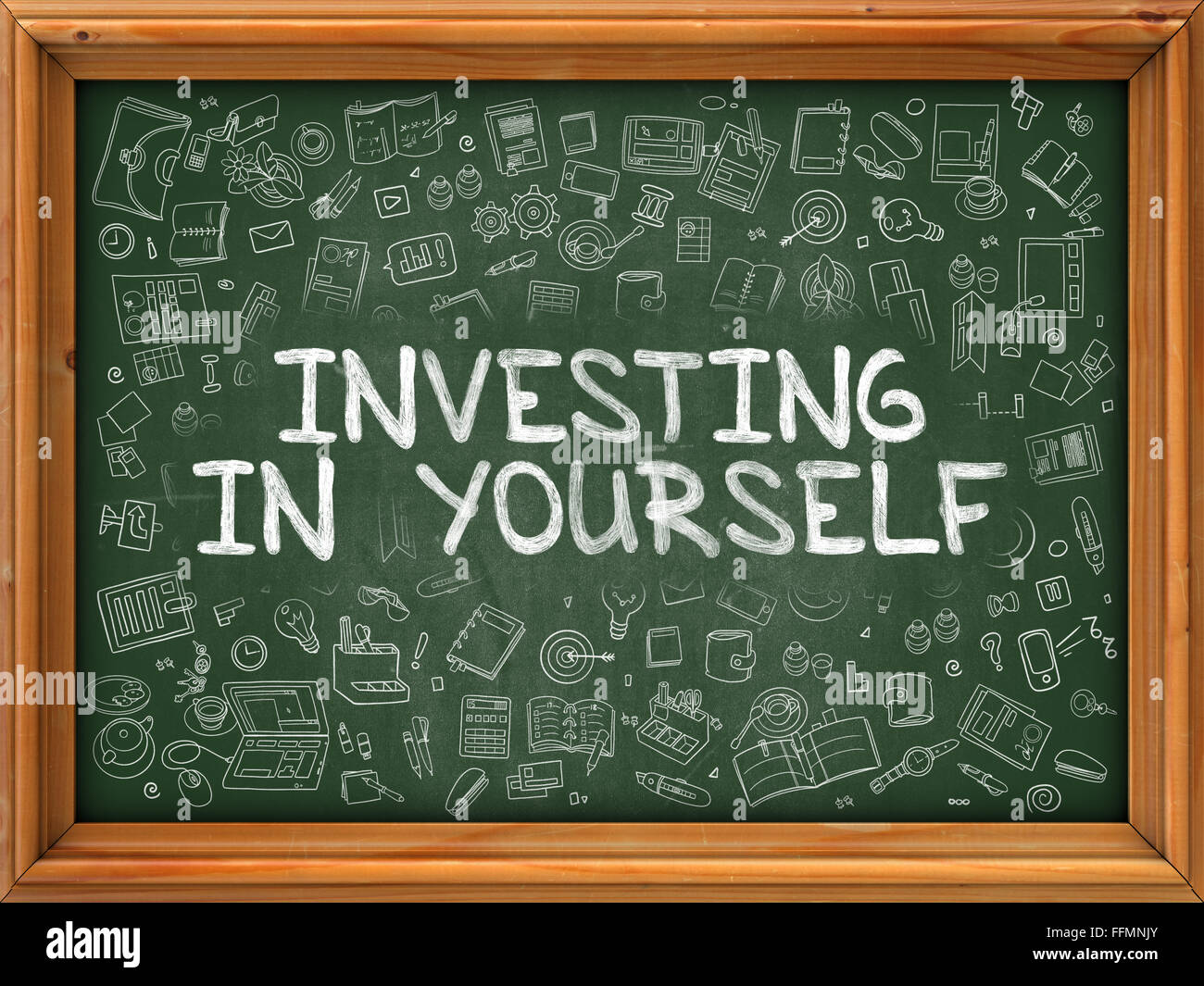 Green Chalkboard with Hand Drawn Investing in Yourself. Stock Photo